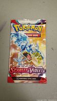 Front of sealed Pokemon Scarlet & Violet booster pack showing Gyarados illustration and branding.