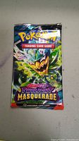 Front of sealed Pokemon Scarlet & Violet Twilight Masquerade booster pack showing the artwork and branding.