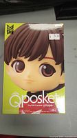 Front view of sealed Qposket TinyTAN J-Hope figure box with character face and price tag visible.