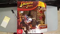 Front of sealed Indiana Jones Akator Temple Race game box showing Indiana Jones character with temple background and game title.