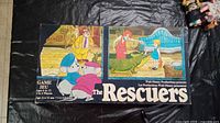 Box cover of The Rescuers board game featuring Disney characters and game title