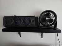 Front view of both fans on shelf