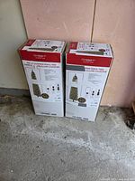 Two boxed Celebrate It 7 ft pre-lit cashmere pencil trees front view