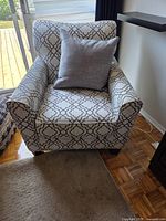 Front view of patterned armchair with cushion