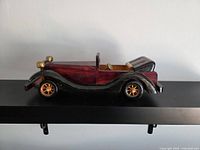 Side profile view of the wooden roadster model showing body, fenders and wheels