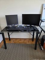 Overall shot of desk with two monitors, keyboards and mouse