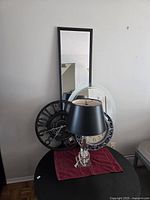 Group view of tall mirror, two clocks, round mirror and acrylic lamp