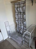 Group view of two white metal shoe racks, two silver mesh shoe racks, garment trolley components and hanging organizer