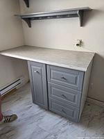Front view of cabinet with countertop and wall shelf