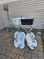Full view of drying rack with two curved white baskets leaning and two rectangular baskets on top