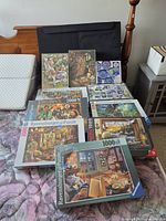 All nine puzzle boxes, trays and rolled mat displayed on bed