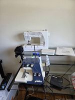 Kenmore sewing machine, White serger, foot pedal on glass table