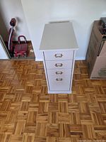 Front view of light grey four-drawer Ikea cabinet