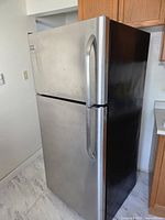 Front view of stainless door refrigerator with top freezer