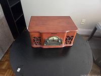 Front view of Electrohome Wellington stereo showing wood cabinet, speaker grilles, radio dial, CD controls