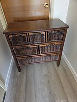 Front view of six-drawer wood and rattan storage unit