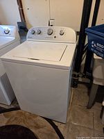 Front and side view of Whirlpool top-load washer