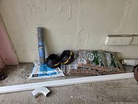 Group view of stone bags, limestone screenings, edging rolls and chicken wire