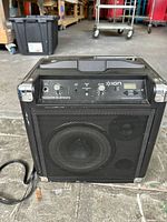 Front view of Ion Tailgater Bluetooth portable speaker showing control panel with knobs, input jacks, and speaker grille.