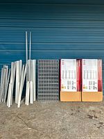 Full lot showing disassembled parts and two boxed units against blue wall