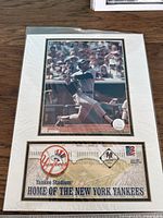 Framed photograph of a Yankees player in mid-swing with signed 2002 first day cover below