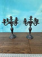 Pair of silver plated five-arm candlestick holders, showing front view with full height and detail.