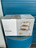 Photo of the product box showing tiered buffet server image and product details