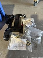 Full kit including tow hitch receiver, wiring harness, and mounting hardware laid on concrete floor