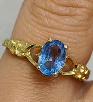 Ring on finger showing overall appearance and sapphire color