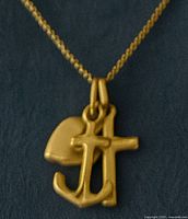 Front view of the pendant with the charms forming a clustered design hanging together on the chain.