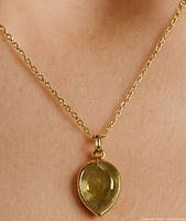 Pendant worn on model to show scale and appearance
