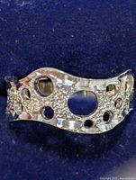 Front view of the sterling silver ring showing textured surface and circular cutouts.