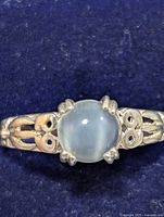 Front view showing the round moonstone and decorative silver band