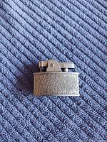 Front view of Ronson Cadet lighter with floral engraving