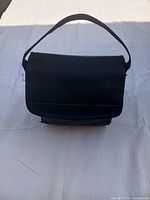 Black fabric carrying case with shoulder strap closed
