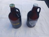 Front view of both amber glass growlers