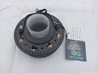 Top view of lantern showing cutout design, glass insert, cord hanger and tag