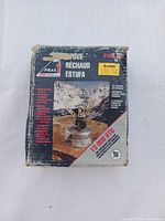 Front of worn Coleman Peak 1 stove box showing model and imagery