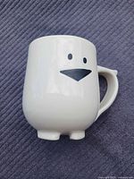 Front view showing face graphic and sculpted feet