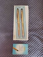 Pen and pencil set in cardboard sleeve insert