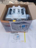 Toaster inside box with packaging and manual visible