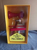 Cabinet front showing horn in situ with pull handle sign