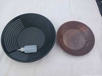 Front view of black plastic pan, metal pan, sniffer bottle