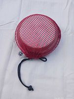 Kit stored inside red mesh drawstring bag