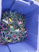 Blue tote filled with green-wire multicolour LED light strings