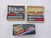 Both Proedge carving sets open showing blades, handles and outer box
