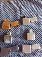 Four Zippo lighters open and closed