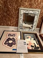 Three framed items including fabric art, an Asian print, and mirror