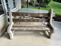 Front view of the outdoor bench showing cement sides and three wooden slats forming seat and backrest
