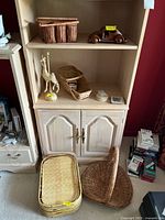 Overall lot items including baskets, giraffe figurine, wooden car, trays and coasters displayed on shelving unit and floor.